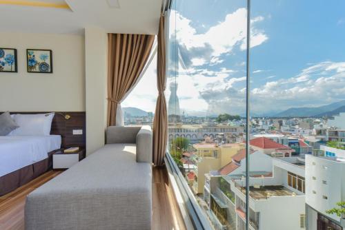 a hotel room with a view of a city at Yen Vang Hotel & Apartment Nha Trang in Nha Trang