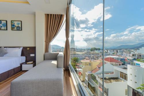 a hotel room with a view of a city at Yen Vang Hotel & Apartment Nha Trang in Nha Trang