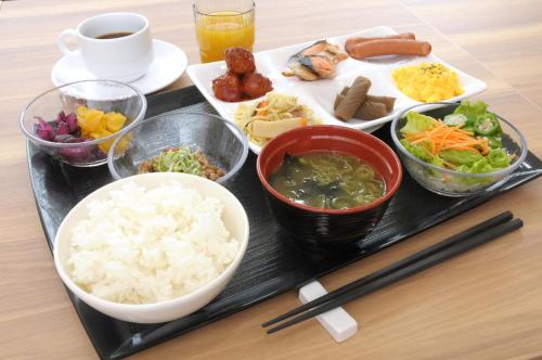 a tray with rice and other foods on a table at AB Hotel Yukuhashi in Yukuhashi