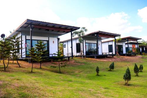 a house with trees in front of it at Mae On Village Resort in Roi Et