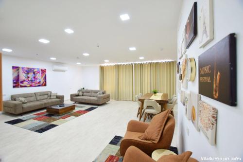 a large living room with couches and a table at LAMITA in Majdal Shams