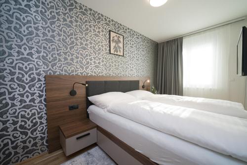 Ένα ή περισσότερα κρεβάτια σε δωμάτιο στο MyApartments Vienna