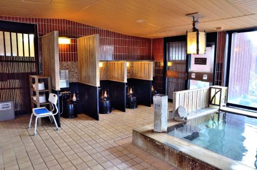 a room with a swimming pool in a building at Dormy Inn Hirosaki in Hirosaki
