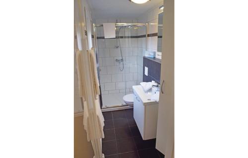 a bathroom with a sink and a toilet and a shower at M13 Hotel in Riol