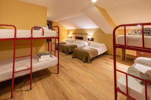 a room with four bunk beds in it at Hotel Port 1730 in La Coma i la Pedra