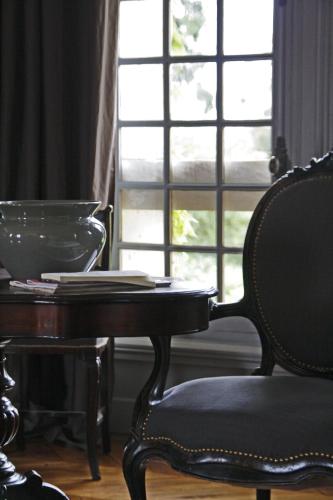 a table and a chair in front of a window at Saint Victor La Grand' Maison in Ingrandes