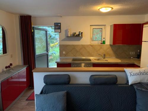 a kitchen with a couch in front of a counter at Bungalow am Wassergrundstück in Wendisch Rietz