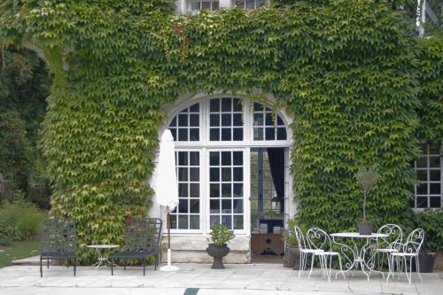 a table and chairs in front of a window at Saint Victor La Grand' Maison in Ingrandes