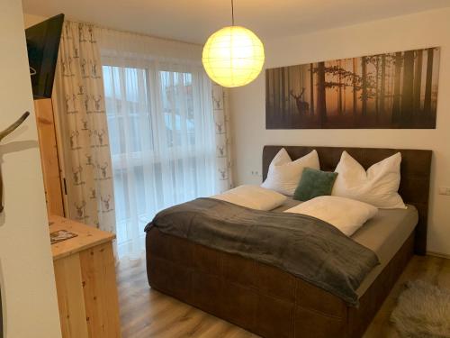 a bedroom with a large bed with a large window at Apart Wexwood in Hart im Zillertal