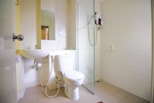 a bathroom with a toilet and a sink and a shower at JL Bangkok Hotel in Bangkok
