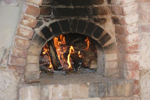 a brick oven with a fire in it at Residenz Nr.6 in Zapfendorf