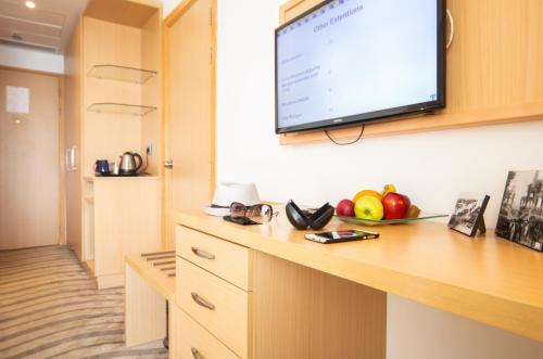 a room with a flat screen tv on the wall at Mercure Ismailia Forsan Island in Ismailia
