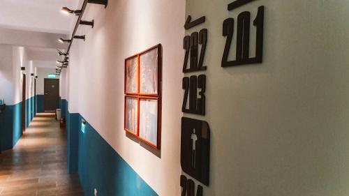 a hallway with black numbers on a wall at Central Woods in Yilan City