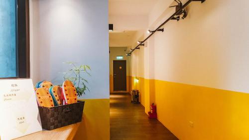 a hallway with yellow and white walls at Central Woods in Yilan City
