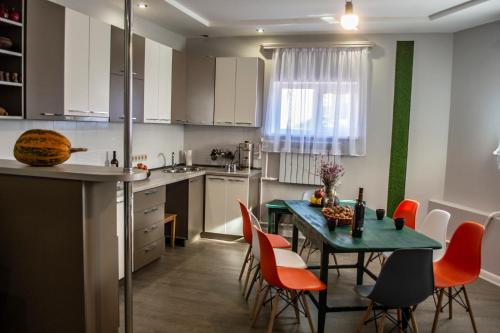 a kitchen with a table and chairs in a kitchen at Stone Art Guest House & Camping in Pemzashen