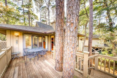 a house with a wooden deck with a tree at Inlet Cove 12 in Kiawah Island