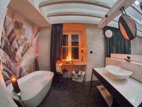 a bathroom with a large tub and a sink at La Vita e Bella IV in Dubrovnik