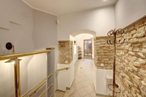 a bathroom with a stone wall and a walk in shower at Vilnius Old town apartments in Vilnius