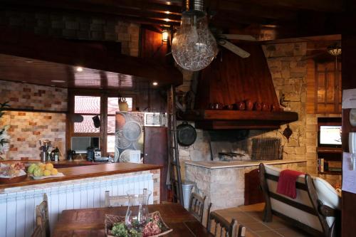 a kitchen with a wooden table and a counter at Casa Escosa in Albalate del Arzobispo