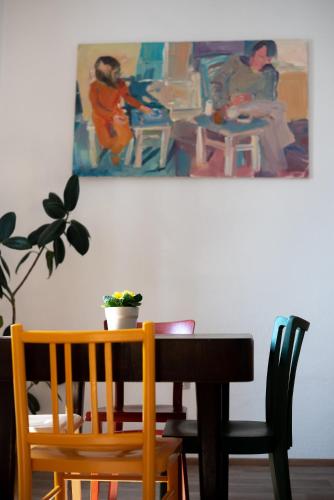 a dining room table and chairs with a painting on the wall at Apartmány16 Olešnice v Orlických horách in Olešnice v Orlických horách