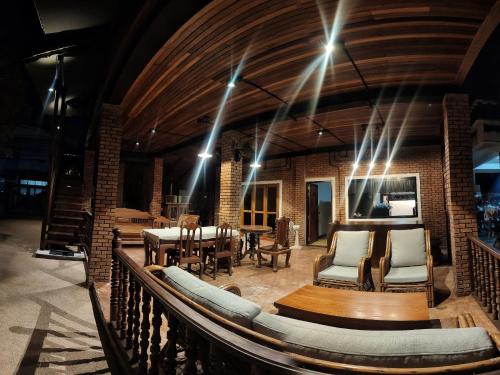 a large room with a table and chairs and lights at Sarah Guest House in Chiang Mai