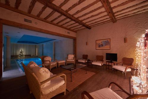 a living room with chairs and a table and a television at Grand Hotel Ukraine in Dnipro