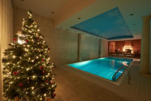 a christmas tree is next to a swimming pool at Grand Hotel Ukraine in Dnipro