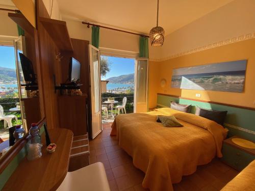 a hotel room with a bed and a balcony at Albergo La Pineta in Marina di Andora