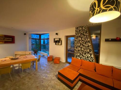 a living room with a couch and a table at Villa Predeal in Predeal