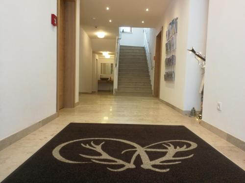 a hallway with a carpet with a symbol on it at Waidmannsruh Appartements in Gerlos