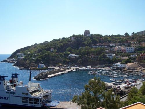 a cruise ship docked in a harbor with boats at Residence Timeo in Ustica