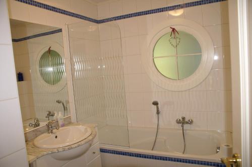 a bathroom with a shower and a sink and a tub at Place des Bons Amis in Saint-Hubert