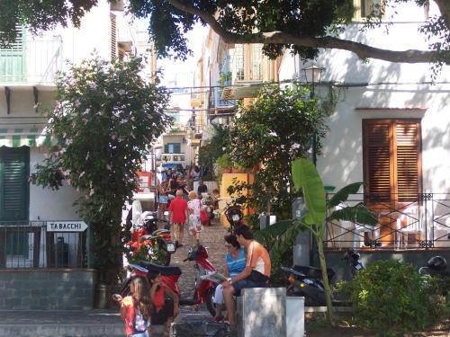 a group of people sitting on motorcycles on a street at Residence Timeo in Ustica