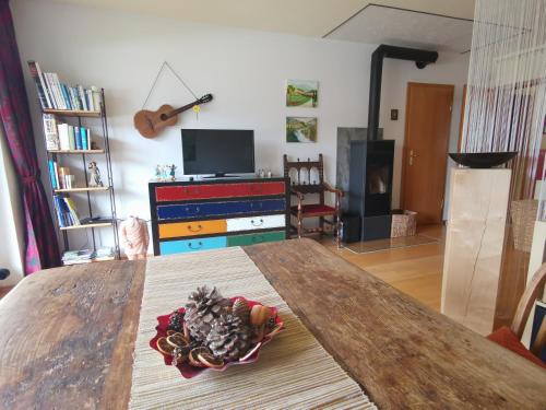 a living room with a table with a bowl of food on it at Gartenblick in Mittenwald