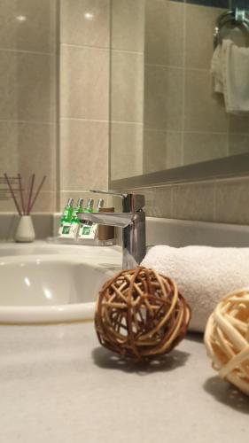 a bathroom with a sink and a roll of towels at Erytha Hotel & Resort Chios in Karfas