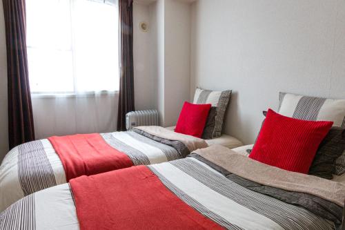 dwa łóżka siedzące obok siebie w pokoju w obiekcie Cosy apartment Sapporo K w mieście Sapporo