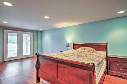 a bedroom with a bed and a blue wall at Cozy A-Frame Center Barnstead House on Locke Lake! in Barnstead