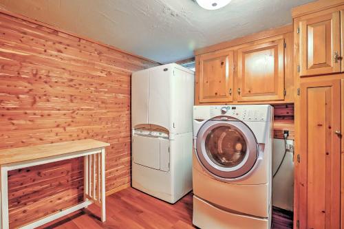 a laundry room with a refrigerator and a washer at Cozy A-Frame Center Barnstead House on Locke Lake! in Barnstead