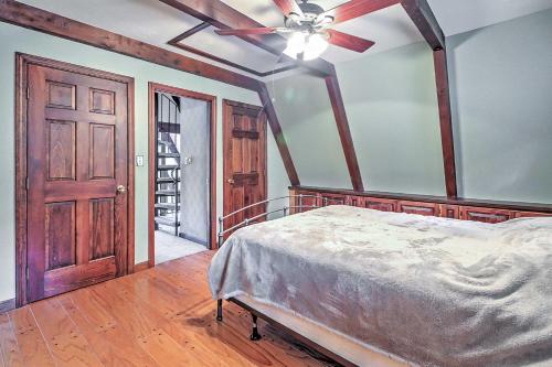 a bedroom with a bed and a ceiling fan at Cozy A-Frame Center Barnstead House on Locke Lake! in Barnstead