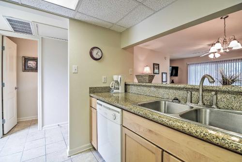 a kitchen with a sink and a counter at Ocean Springs Condo in Waterfront Resort! in Ocean Springs