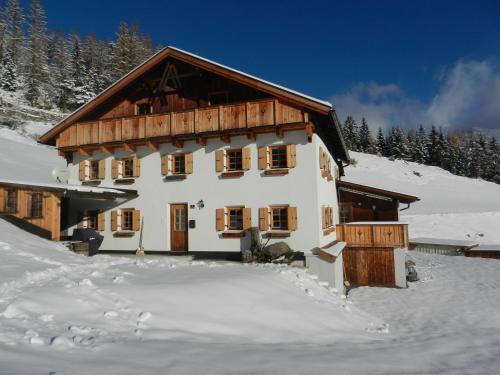 a large house in the snow with snow at Berghütte Schöpf in Umhausen