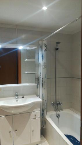 a bathroom with a sink and a shower and a tub at Dalia in Port de Pollensa