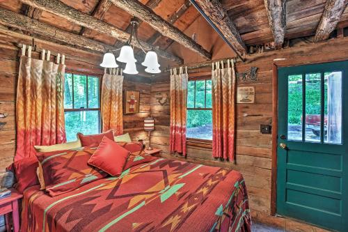 een slaapkamer met een bed in een blokhut bij Private Getaway on 270 Acres with Lake Swim and Canoe in Marble Hill