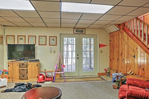 a living room with a flat screen tv at Stamford Lakefront Home with Dock and Wraparound Deck! in Stamford