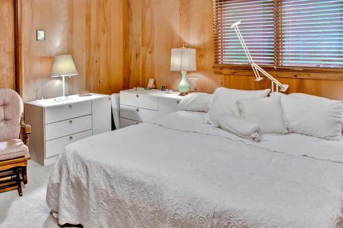 a bedroom with a bed and a desk and a chair at Hike, Fish and Boat Waterfront Home in Brainerd! in Brainerd