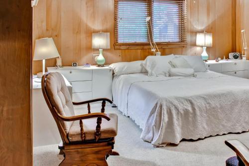 a bedroom with a bed and a chair and a desk at Spacious Brainerd Home by Dwtn - Summer Paradise! in Brainerd