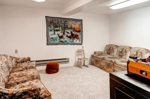 a living room with a couch and a painting on the wall at Charming Tropic Home by a Farm Near Bryce Canyon! in Tropic