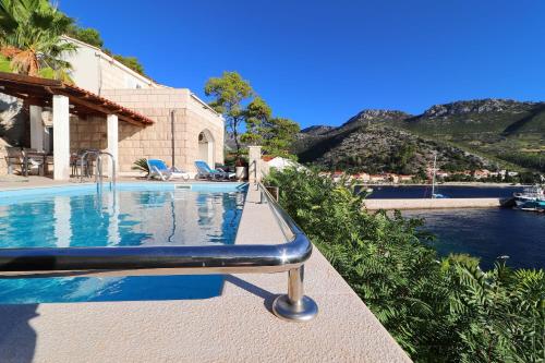 a swimming pool in front of a house at Villa Silencia in Trstenik