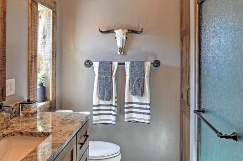 a bathroom with two towels and a cow head on the wall at Rustic Chic Home 10 Mi to Otter Creek State Park! in Circleville