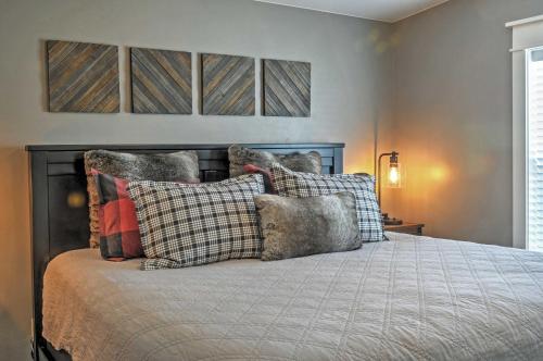 a bedroom with a bed with pillows on it at Rustic Chic Home 10 Mi to Otter Creek State Park! in Circleville